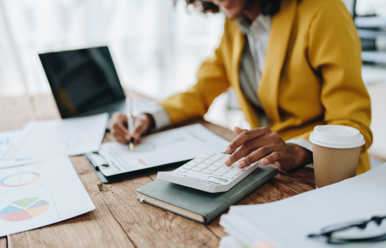 female doing accounting at her work desk